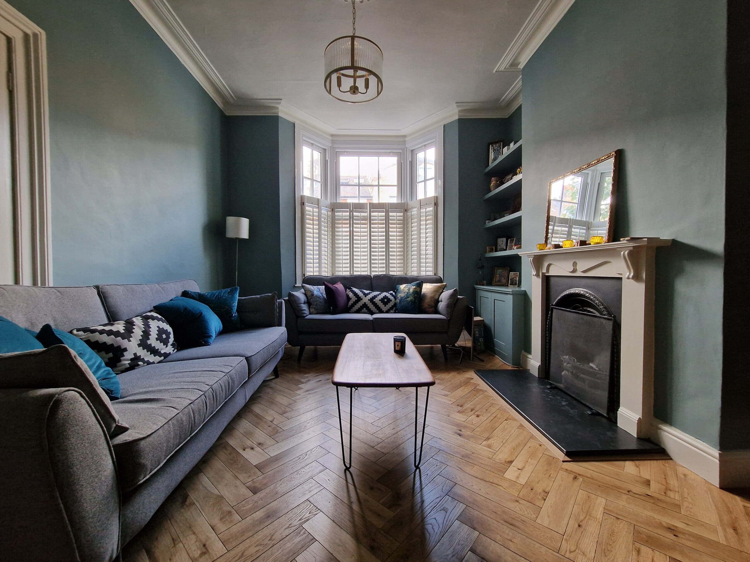 teal living room with wood floor